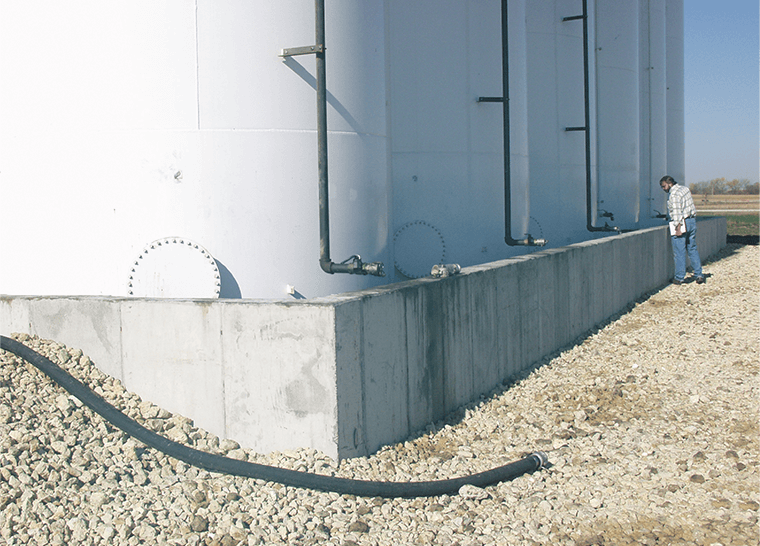 An IWRC environmental specialist inspects secondary containment unit at gasoline distribution facility