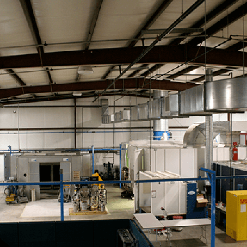 Overlook of painter training facility showing spray and powder booths
