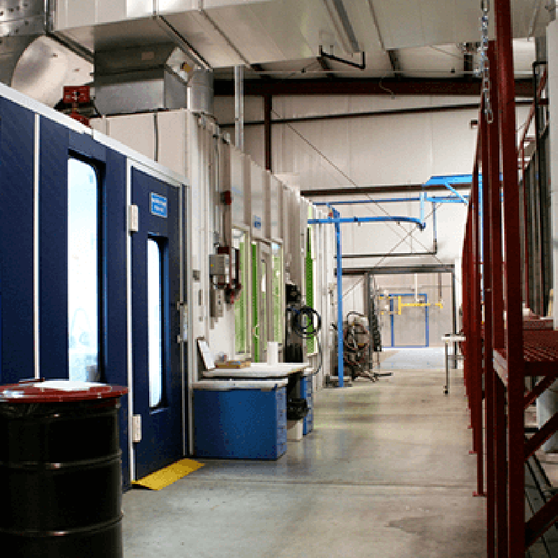 View of mixing room and cross draft spray booth on the left, parts washer on the right