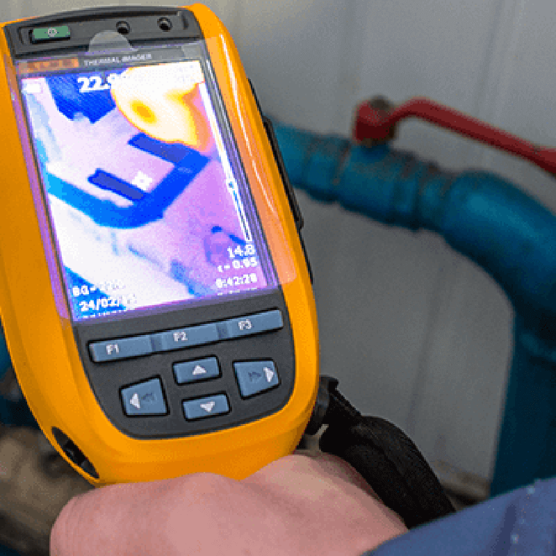 Link, IWRC staff member uses leak detector to perform free energy assessment for a local business.