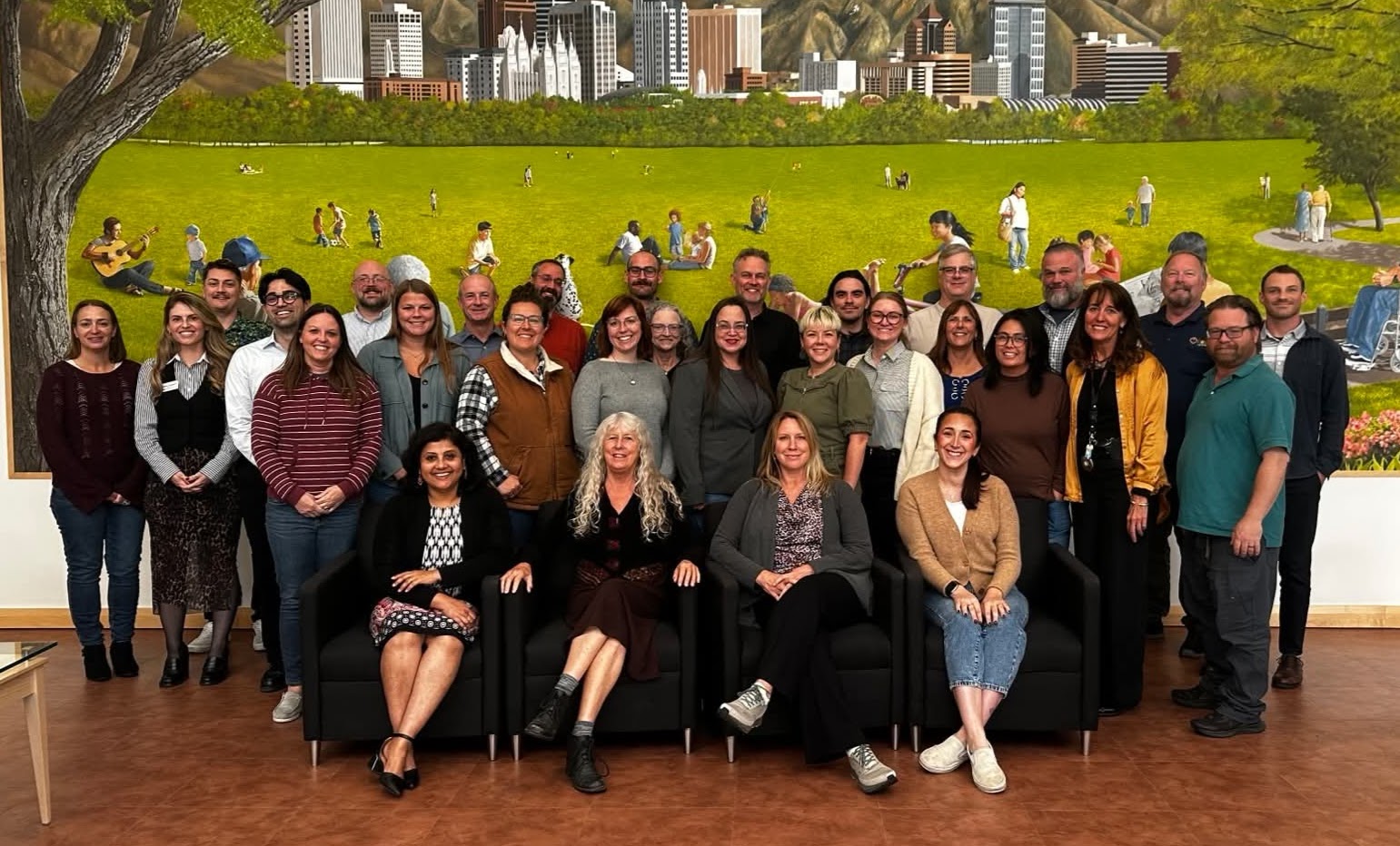 group of men and women posed in front of art wall of Salt Lake City Utah at National SBEAP training
