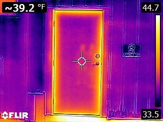 exterior door to a machine shed colored purple and orange highlighting thermal energy