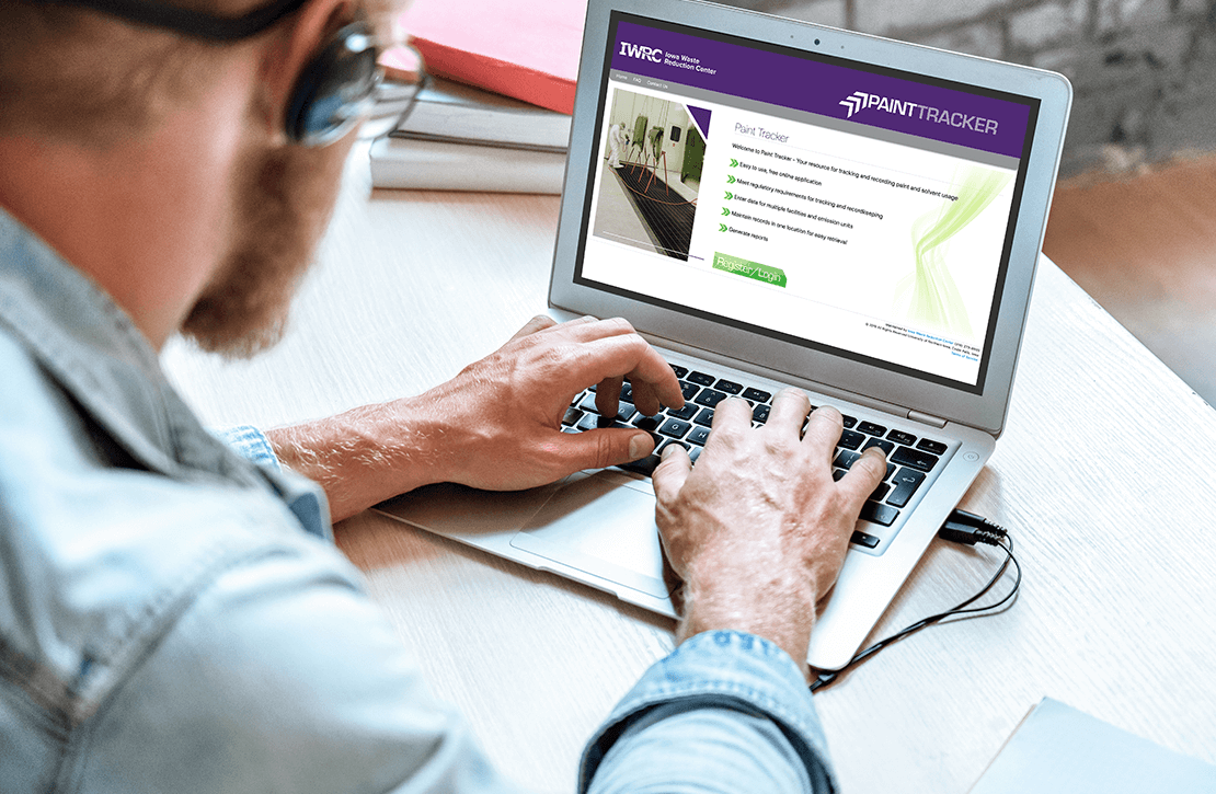 Man using laptop computer to access his account on Paint Tracker recordkeeping web application