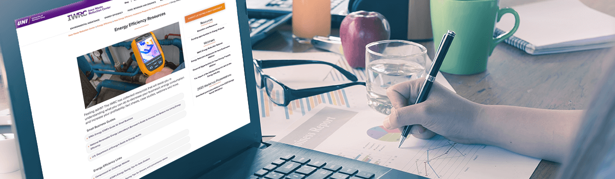 A business person takes note at her desk while an open laptop shows the webpage for Energy Efficiency for Small Business.